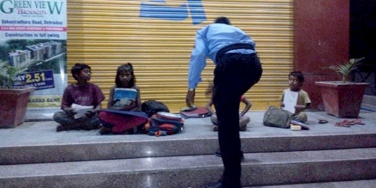 Army personal teaching street children under ATM